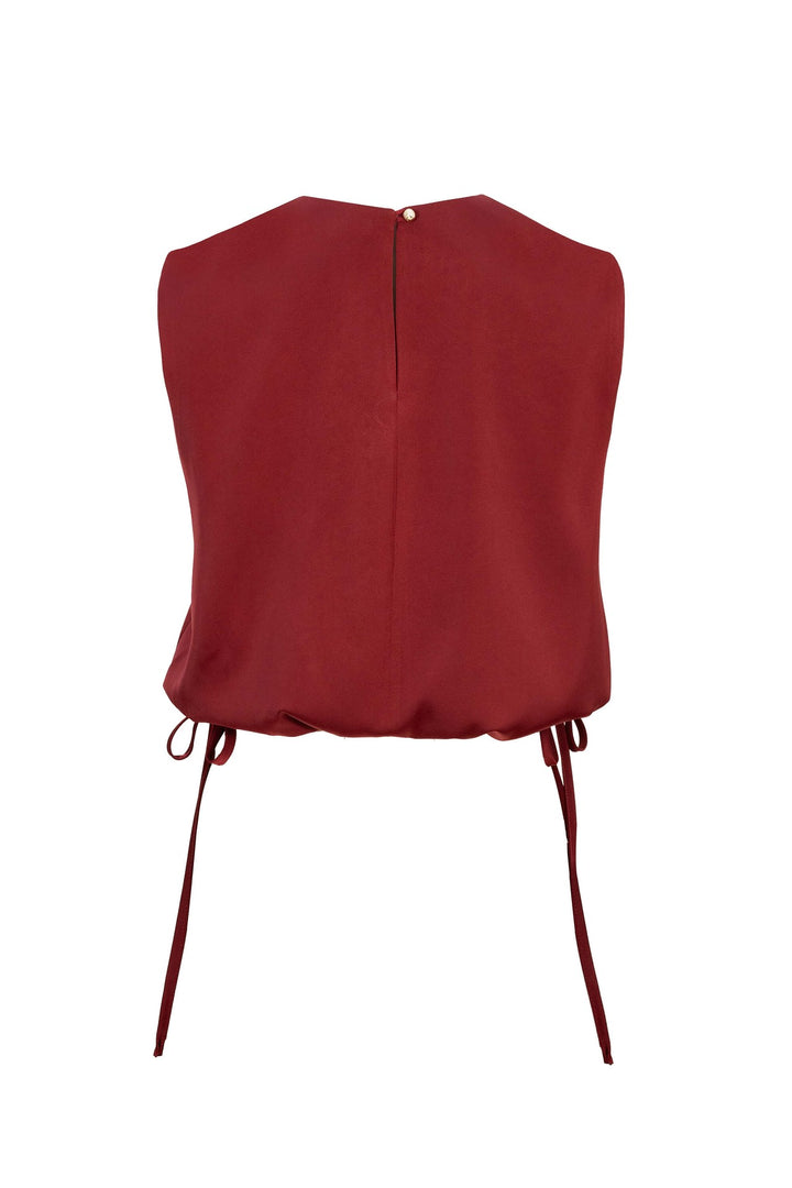 Blusa satinada sin mangas con lazo lateral